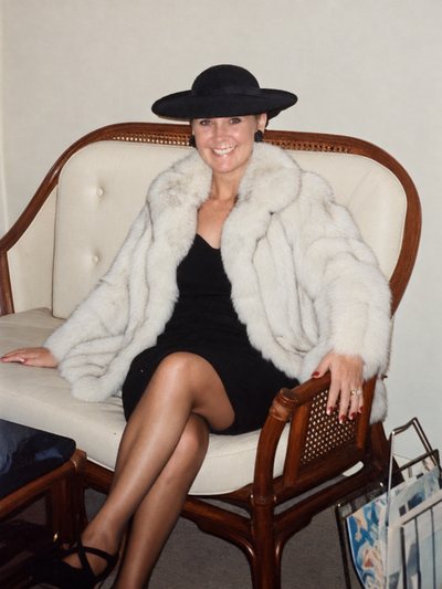 Jimi Gill’s mother seated in a fur coat and wide black hat.