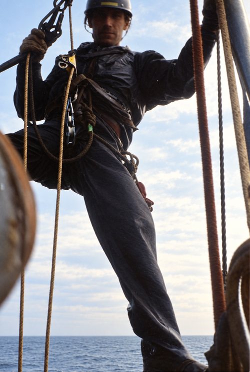 Jimi Gill suspended on ropes above open sea, Brent Alpha, North Sea.